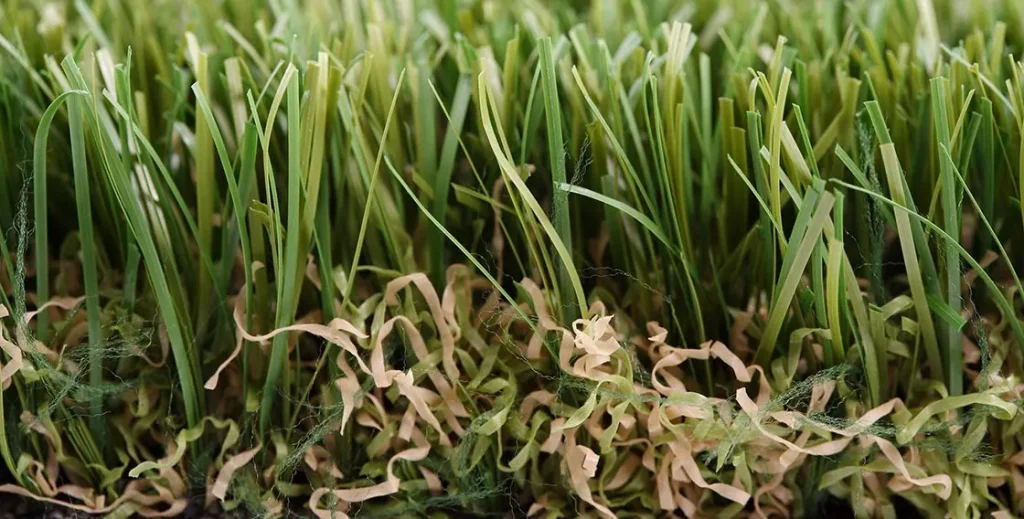 Close-up of artificial grass with green and brown strands